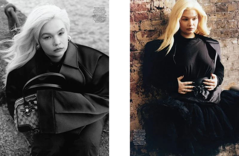 Editorial fashion shot featuring a woman with platinum blonde hair wearing a black coat and holding a Gucci handbag in an outdoor setting.
