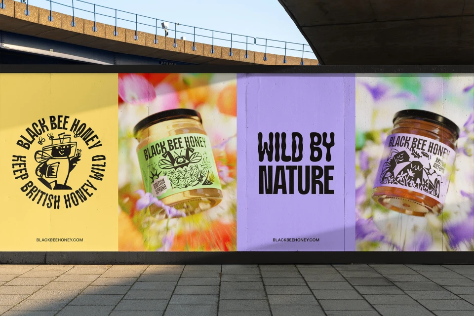 Outdoor billboard featuring Black Bee Honey jars and branding on yellow and purple backgrounds, with sidewalk visible in the foreground.