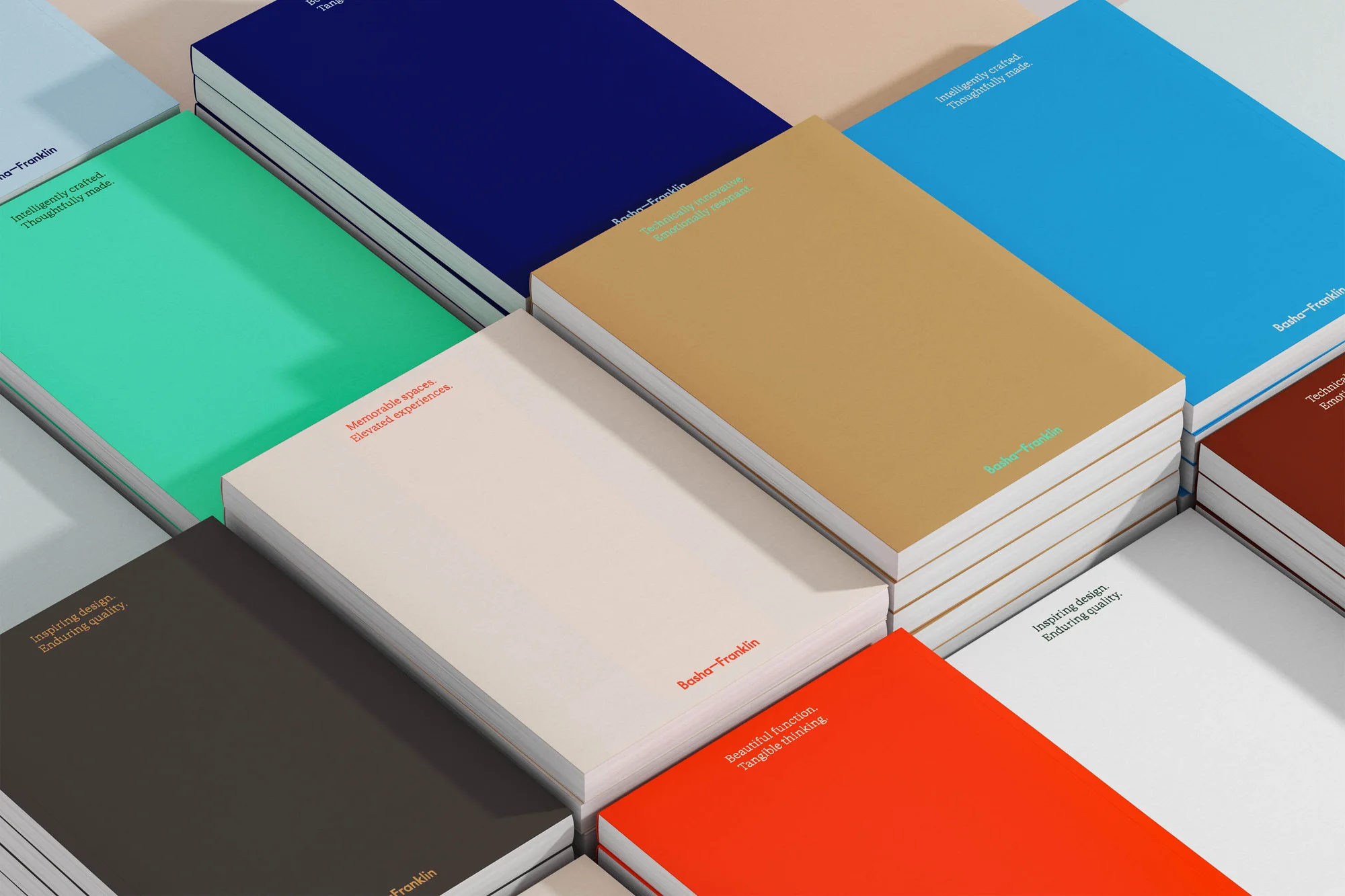 Stacks of colorful hardcover notebooks, each with the brand name Bosho-Franklin printed on the cover, creating a geometric pattern.