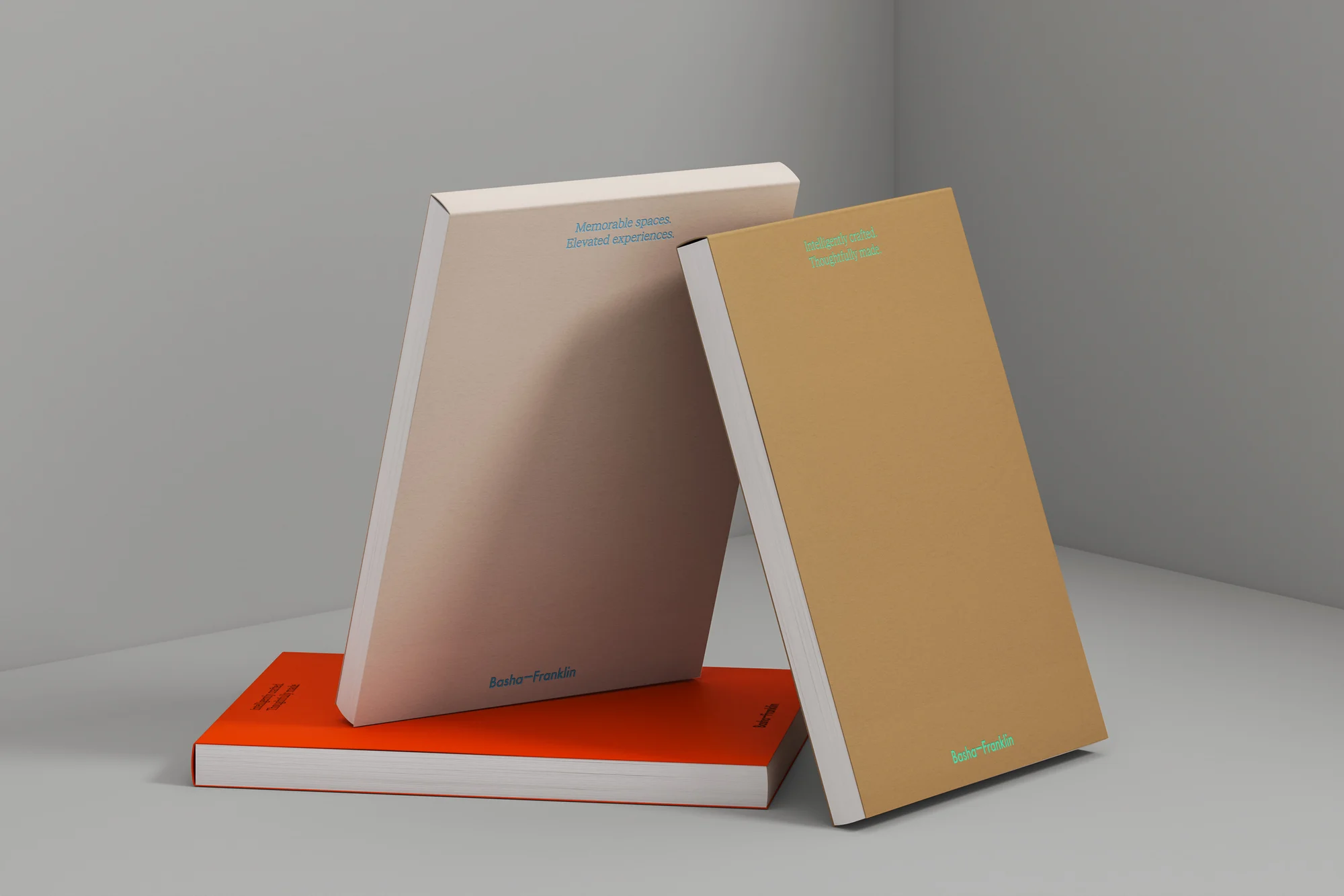 Stack of books in a studio setting, including orange, beige, and brown covered books, with minimalist design and clean presentation.