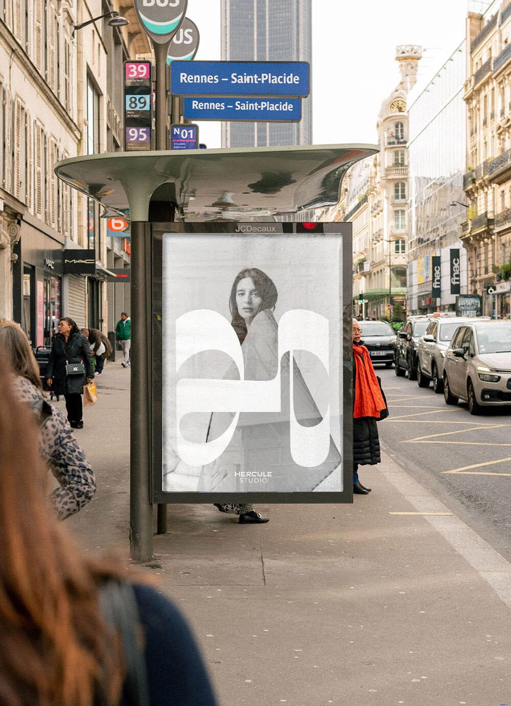 City street view featuring an ad for Hercule Studio on a bus stop, with pedestrians and parked cars in a daytime urban setting.