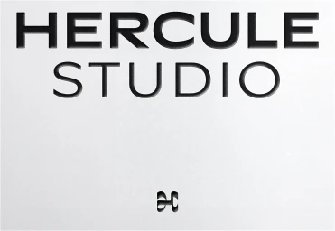 Embossed black typography reading Hercule Studio on a clean white paper background with a small monogram mark.