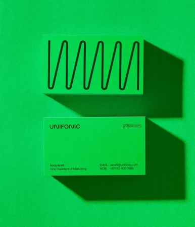 Two bright green Unifonic business cards displaying minimalist typography and a geometric wave line on a solid green background