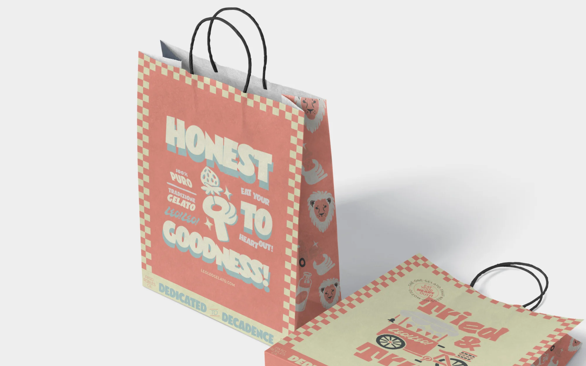 Two promotional paper shopping bags with graphic text and illustrations for Honest brand gelato, shot in a studio with white background.