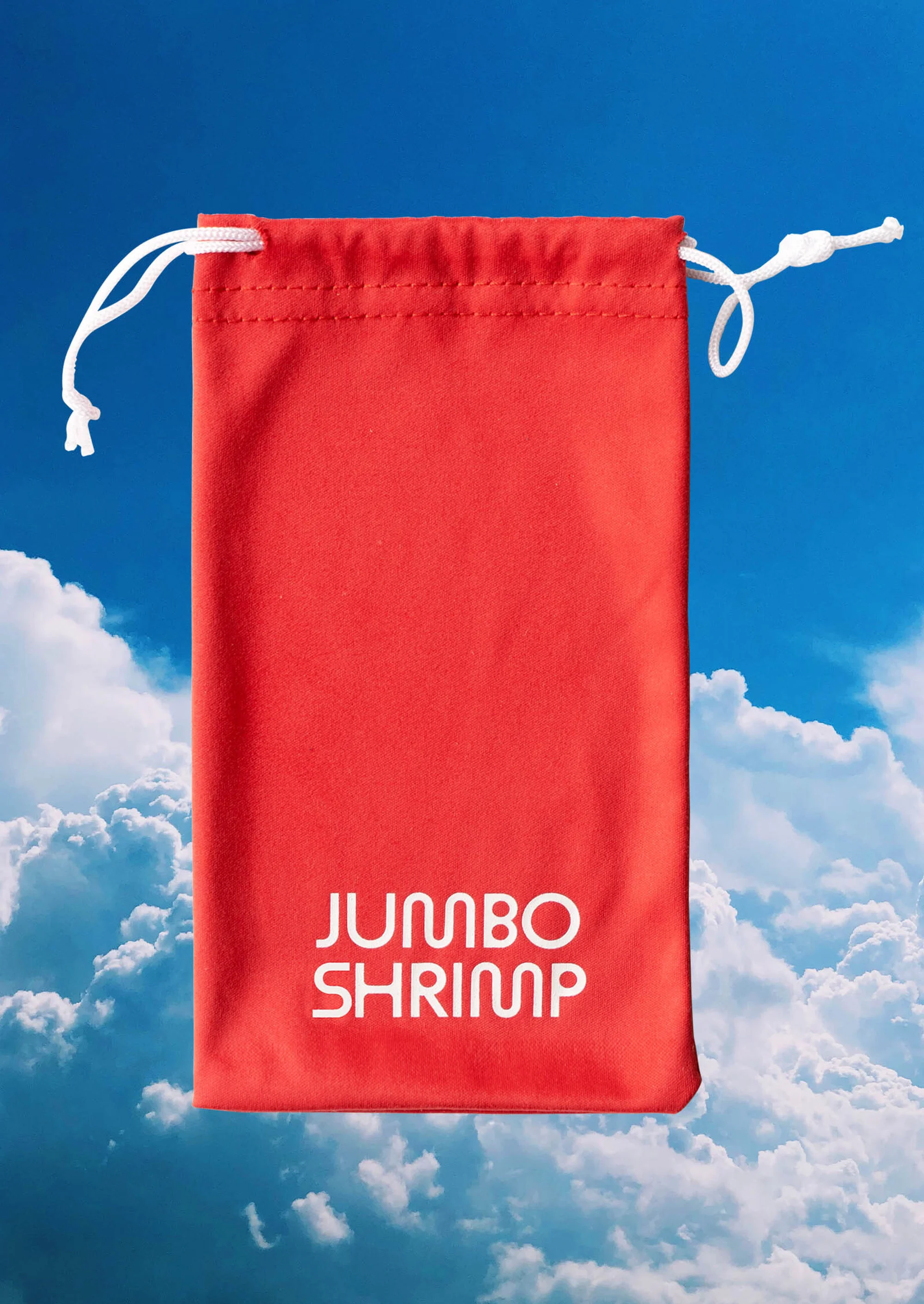 Red drawstring bag with the words 'Jumbo Shrimp' in white, set against a background of blue sky and fluffy white clouds.