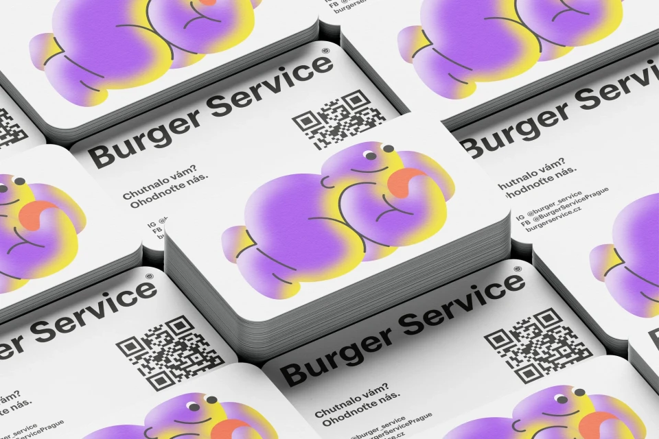 Stack of business cards featuring an illustrated cartoon character and business details for Burger Service, a food and beverage company.