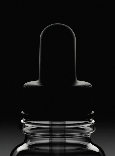 Close-up monochromatic product shot of a dark glass dropper bottle cap against a dark background.