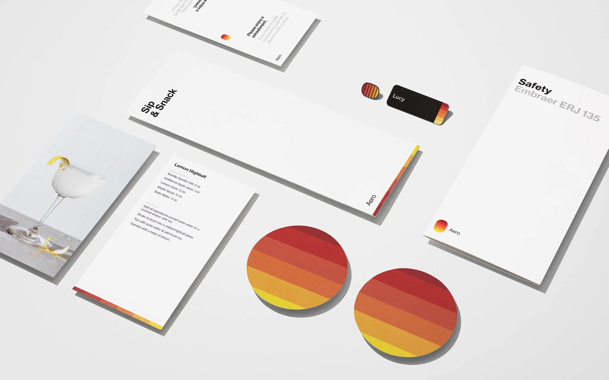 Promotional material featuring cocktail recipe, airplane safety instructions, stationery, and branded items on a white background.