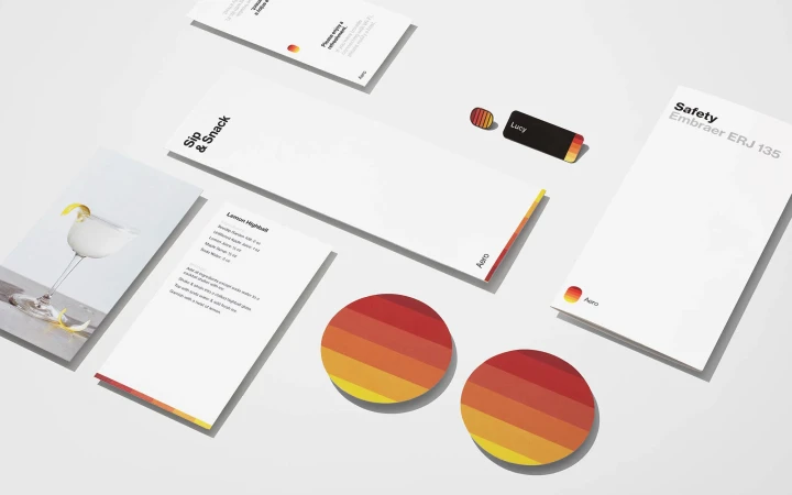 Promotional material featuring cocktail recipe, airplane safety instructions, stationery, and branded items on a white background.
