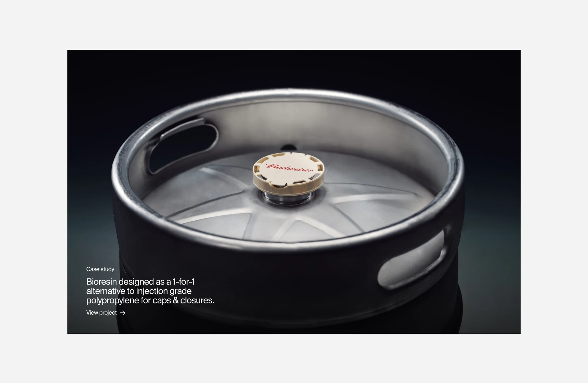 Close-up of a stainless steel beer keg with a cap, product photography showcasing bioresin as a polypropylene alternative for caps and closures.