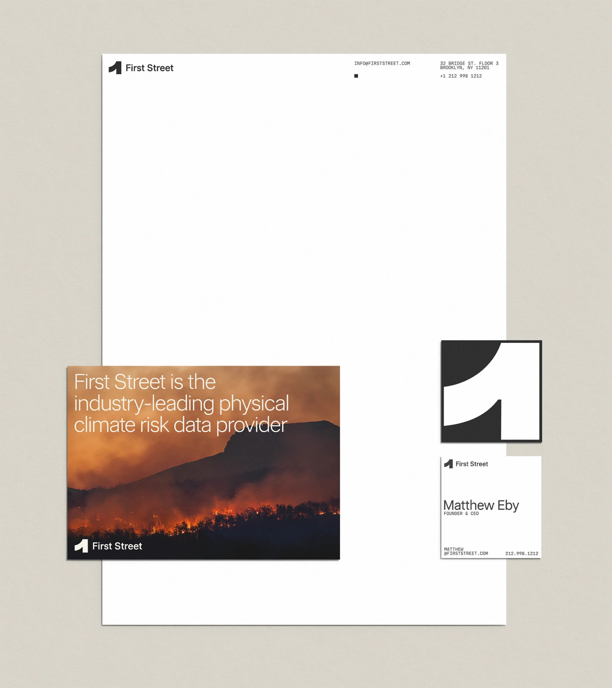 Stationery design showcasing climate risk data provider First Street, featuring business cards, letterhead, and related branding elements.