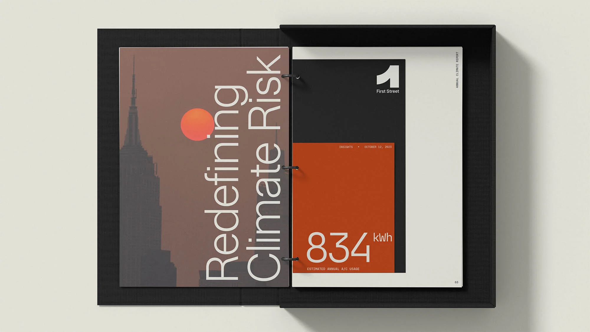 Open black binder with typography and a building graphic, against a light gray backdrop in a studio setting showcasing graphic design.