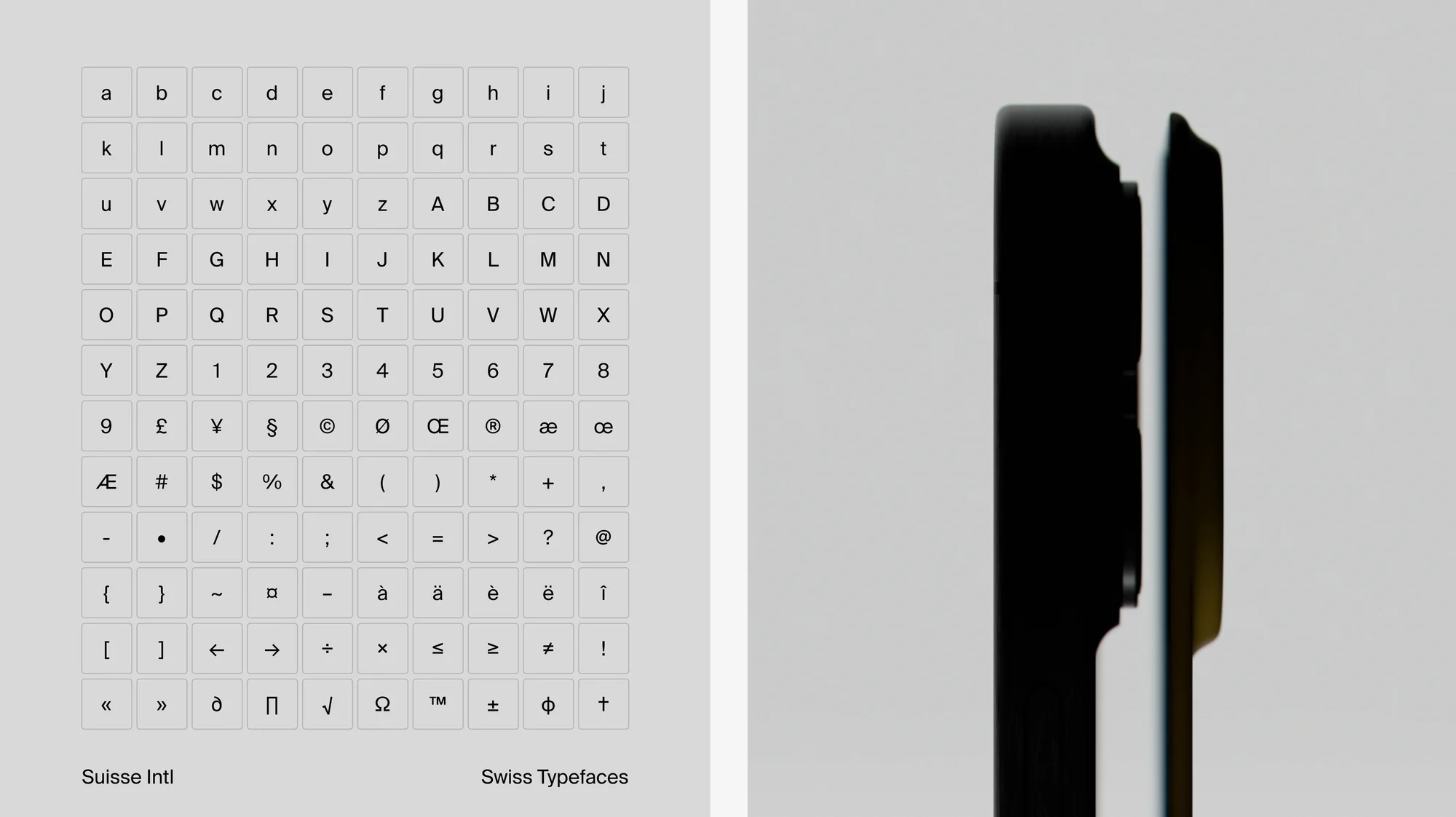 A grid of letter and symbol keyboard keys on the left with a close-up of the edge of two black tablets on the right.