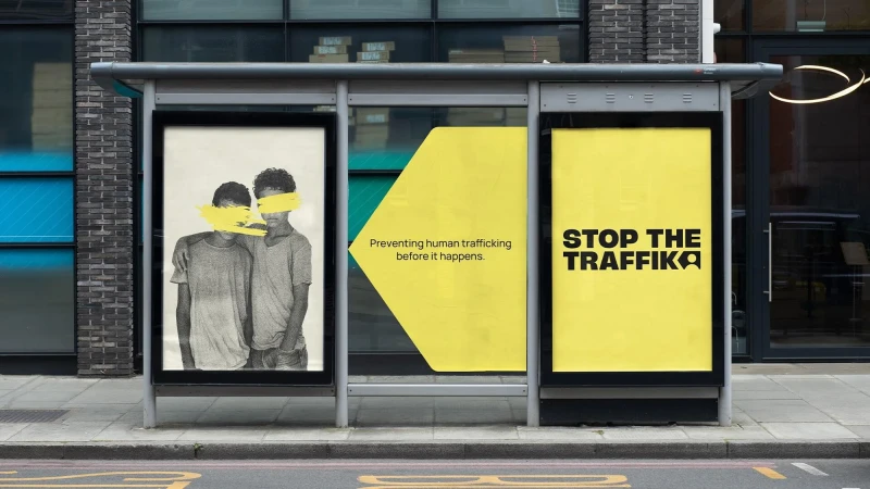 Bus stop advertisement featuring two young people with their eyes covered and text "Stop the Traffik" to raise awareness of human trafficking.