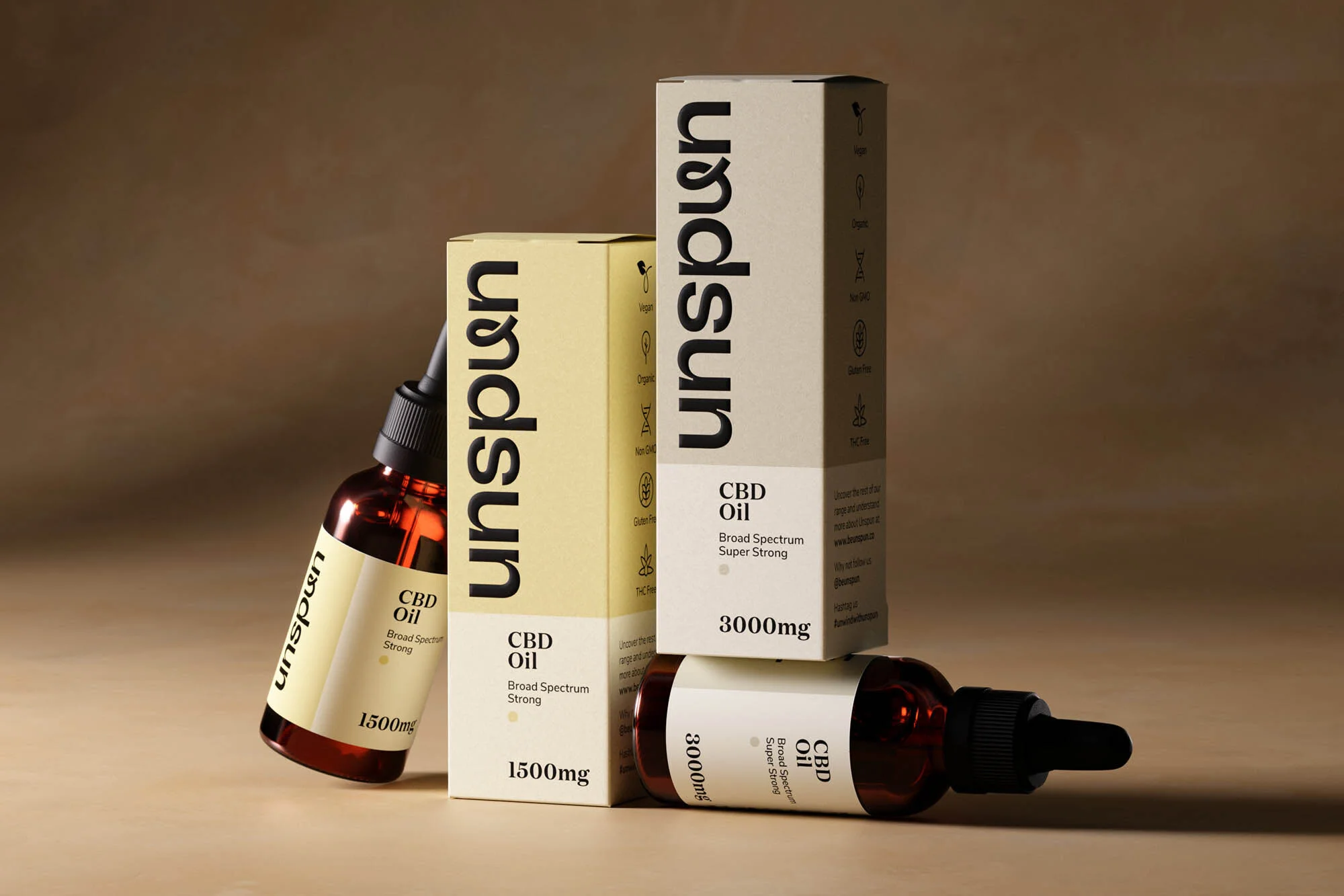Close-up of Unspun CBD oil bottles and packaging in tan and amber tones, emphasizing product details and minimalistic design.