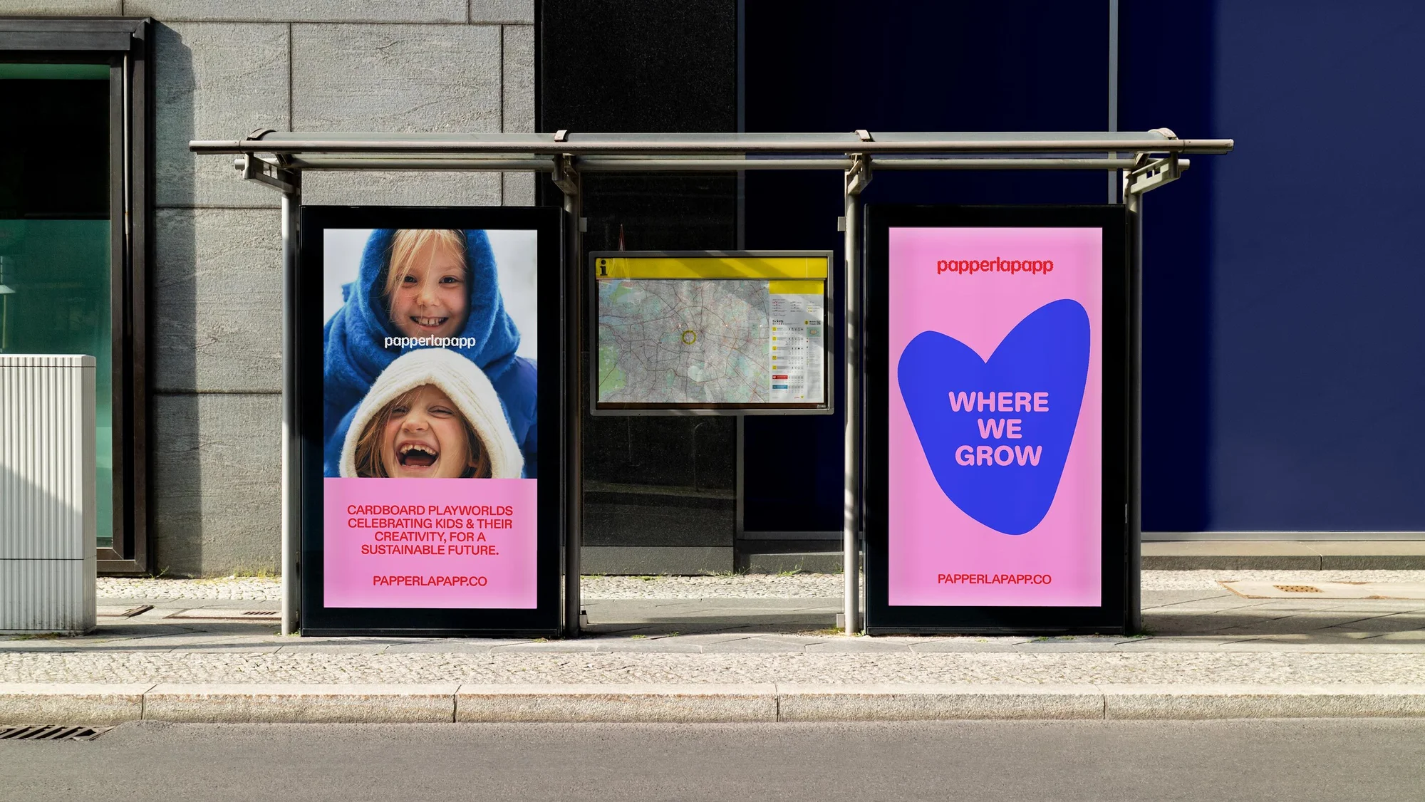Outdoor advertising featuring two happy children in hoodies and a heart design for Papperlapapp, promoting kids' creativity and sustainability.