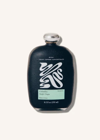Dark bottle of ELDO craft coffee concentrate with a white logo and label, set against a solid off-white background in a studio product shot.
