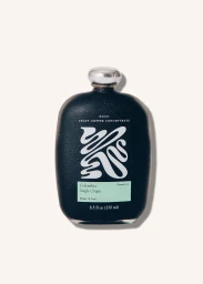 Dark matte flask bottle of Kloo craft coffee concentrate with a silver cap and a pale green label against a white background