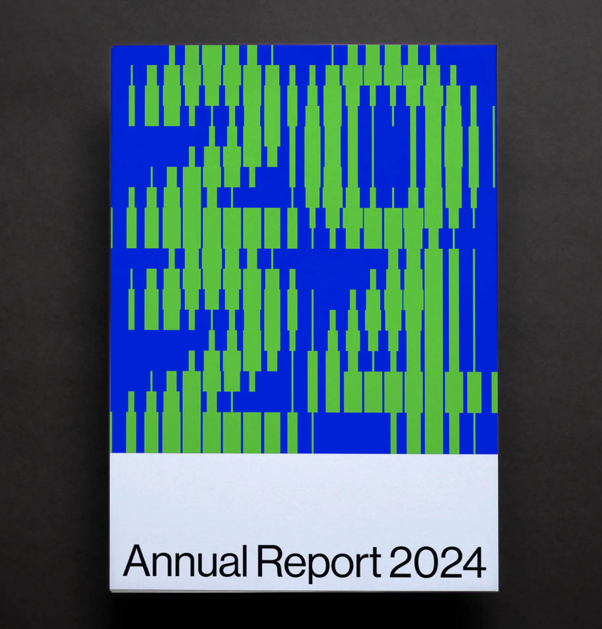 Graphic design on an annual report cover features green bars on a blue backdrop with the words 'Annual Report 2024' in black.
