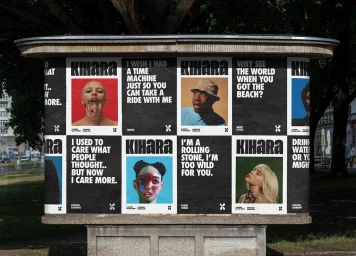 Urban advertising kiosk plastered with KIHARA posters featuring portraits and bold typography