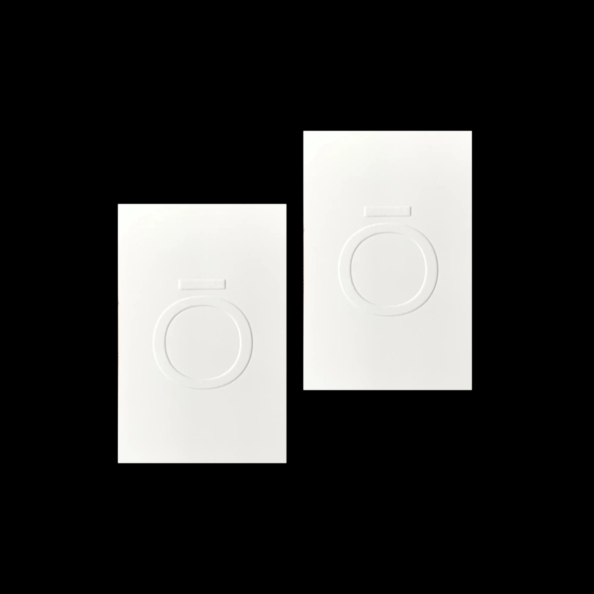 Two white, embossed logo cards on a dark background. The minimalist design features a circular emblem with a horizontal line detail.