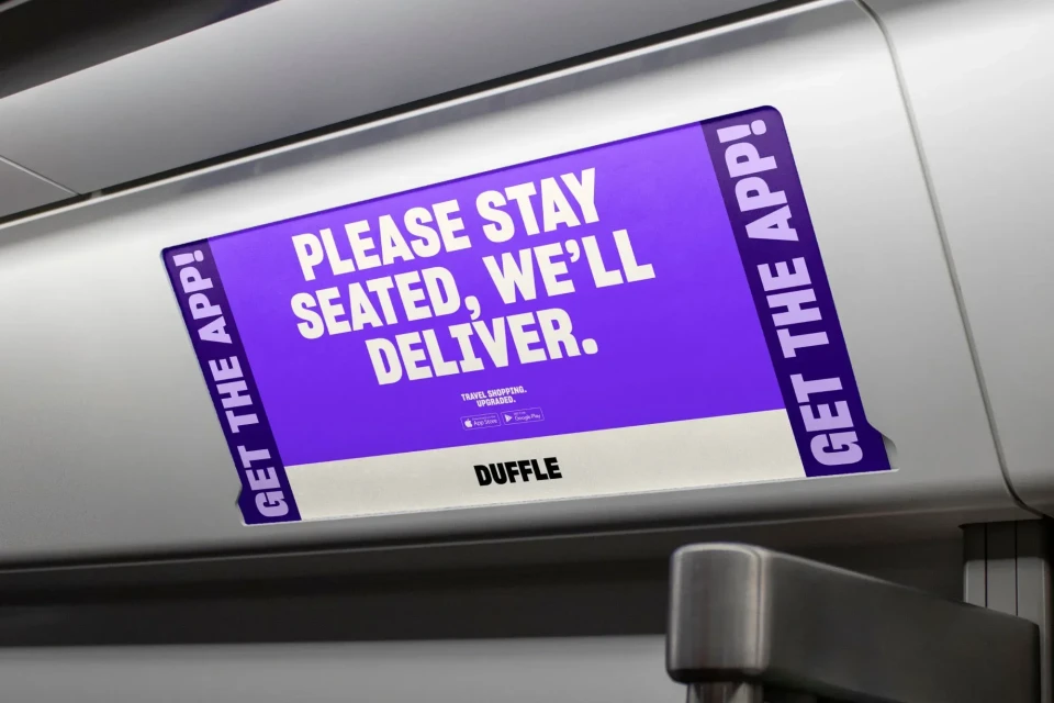 Advertisement on the interior of what looks like a train featuring a message about travel and delivery app services.