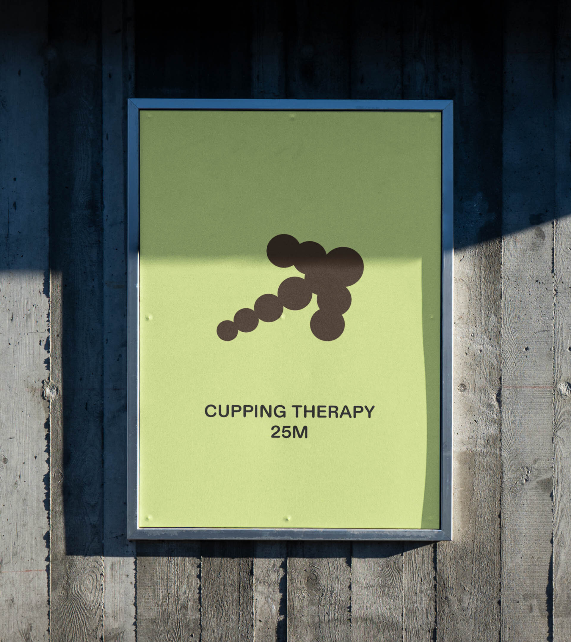 Sign on a weathered wall advertising cupping therapy, featuring a circular arrow symbol and the text 'Cupping Therapy 25M'.