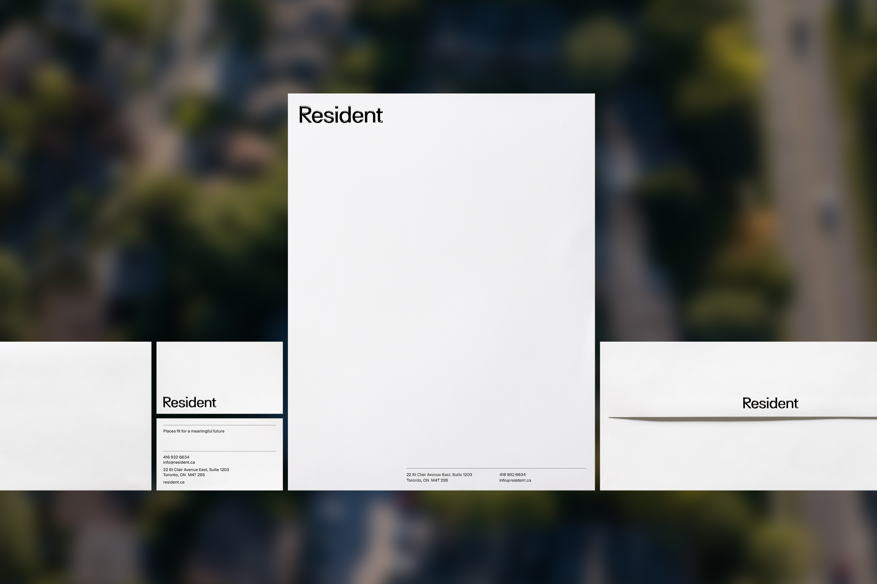 Graphic design featuring 'Resident' on white paper, minimalist aesthetic with an aerial background emphasizing modern, clean branding.