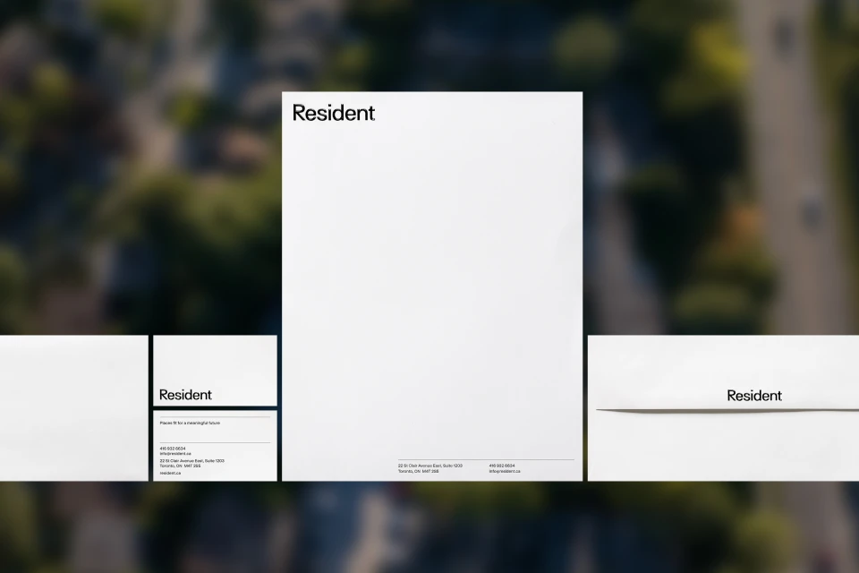 Graphic design featuring 'Resident' on white paper, minimalist aesthetic with an aerial background emphasizing modern, clean branding.