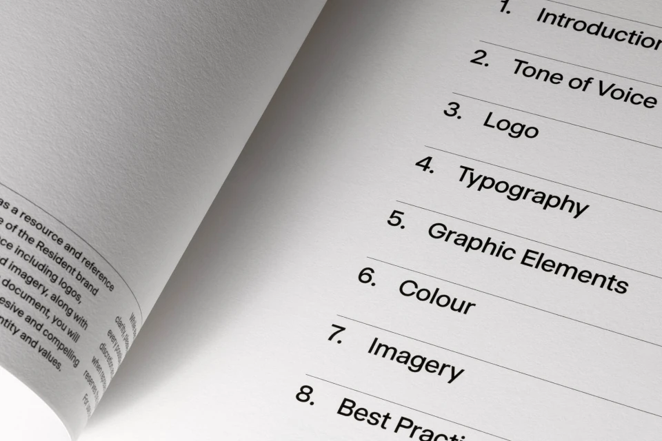 Open book displays table of contents: Introduction, Tone of Voice, Logo, Typography, Graphic Elements, Colour, Imagery, Best Practice.