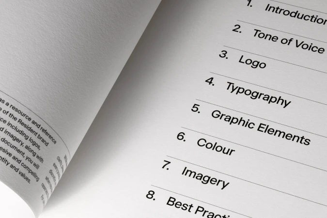 Open book displays table of contents: Introduction, Tone of Voice, Logo, Typography, Graphic Elements, Colour, Imagery, Best Practice.