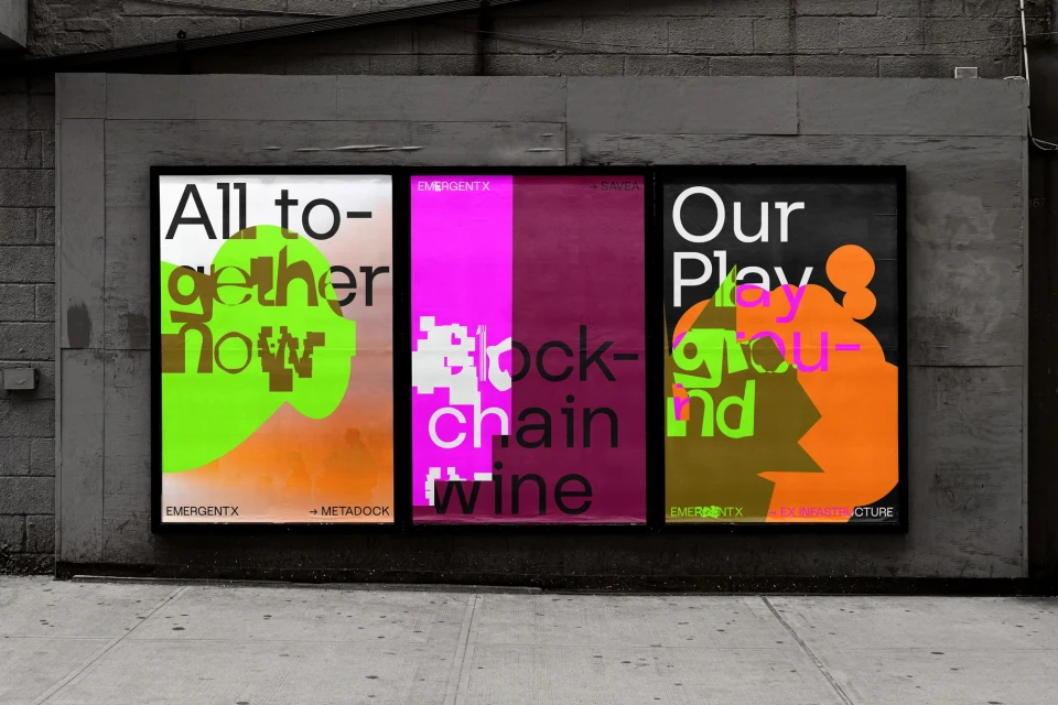 Three vibrant, vertically-oriented posters attached to a weathered grey wall. The posters feature bold typography and contrasting colors.