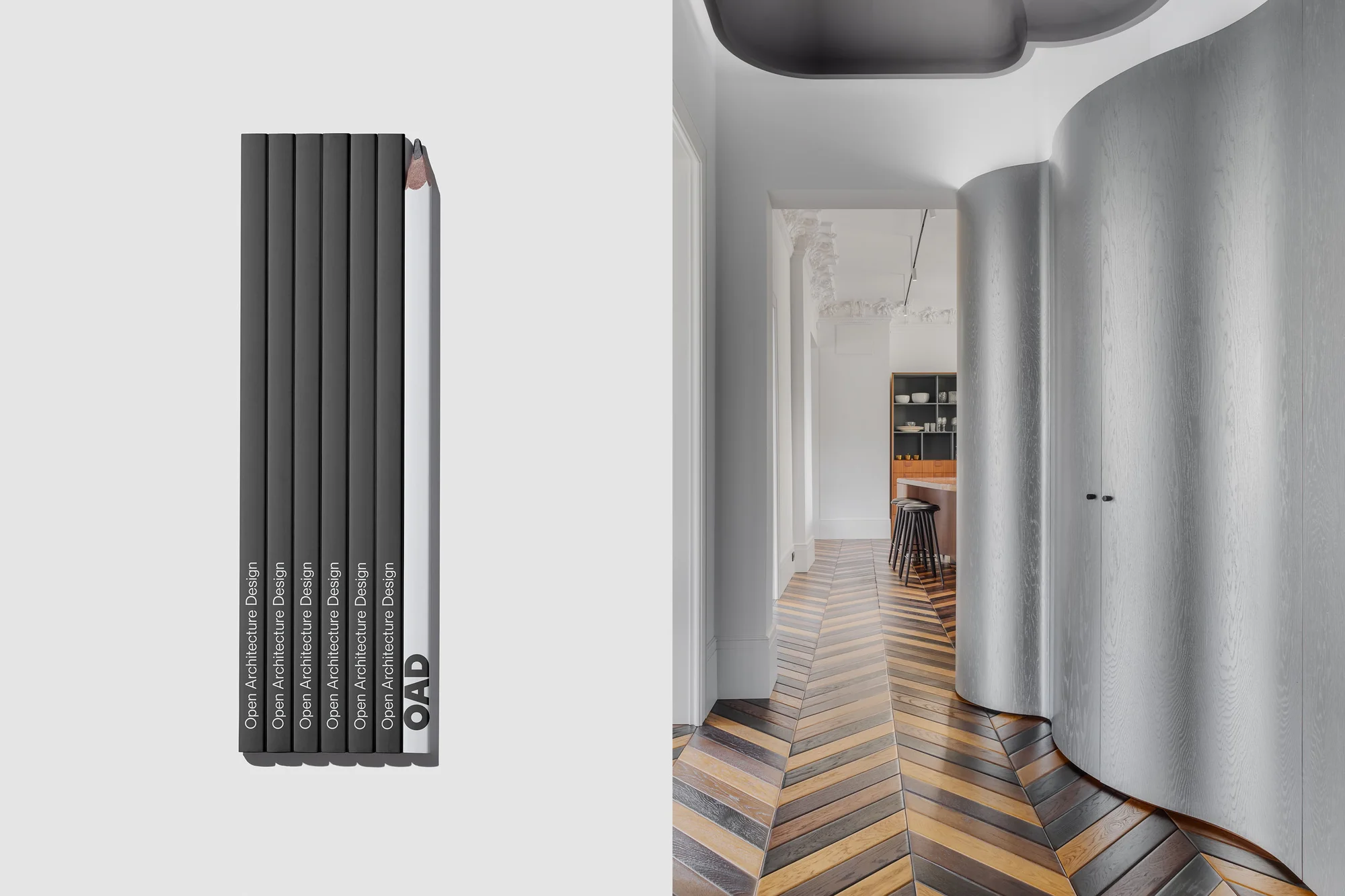 Interior design elements showcase modern architecture with gray-toned walls, wood herringbone floors, and a stack of OAD design books.