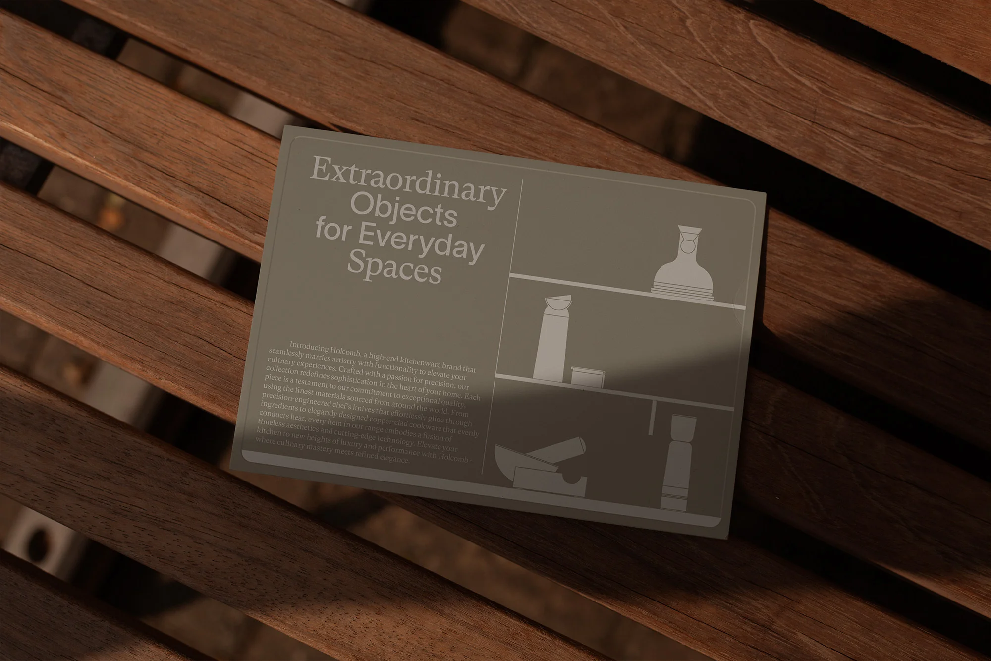 Book titled 'Extraordinary Objects for Everyday Spaces' sits on a wooden slatted surface in soft lighting, showcasing simple design.