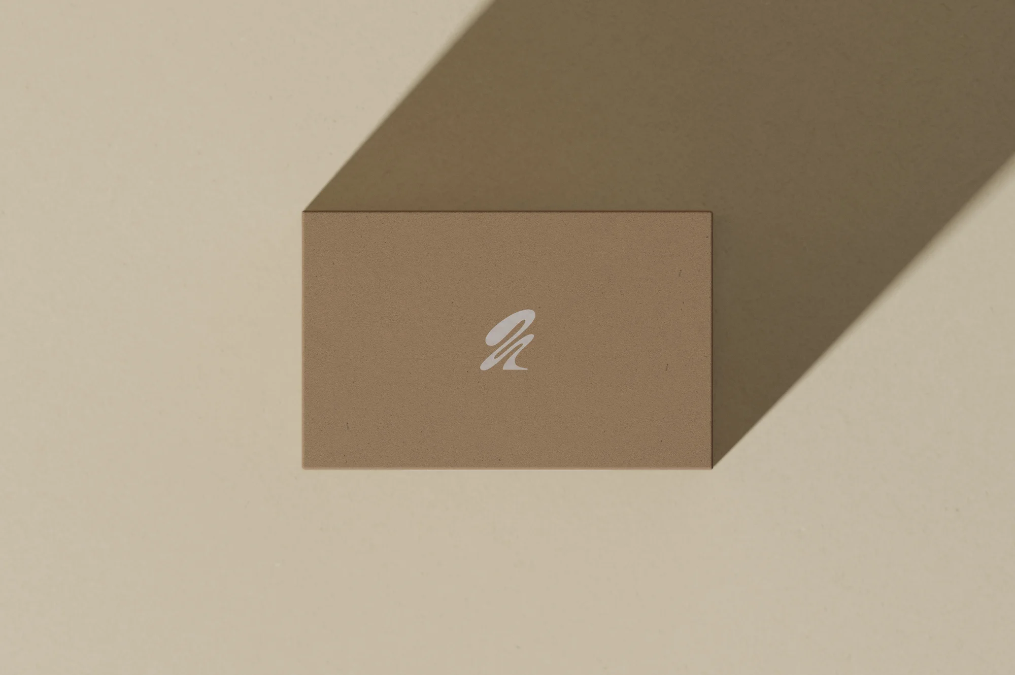 Minimalist business card design with soft shadow on a neutral background. Clean, modern aesthetic for corporate branding and advertising.