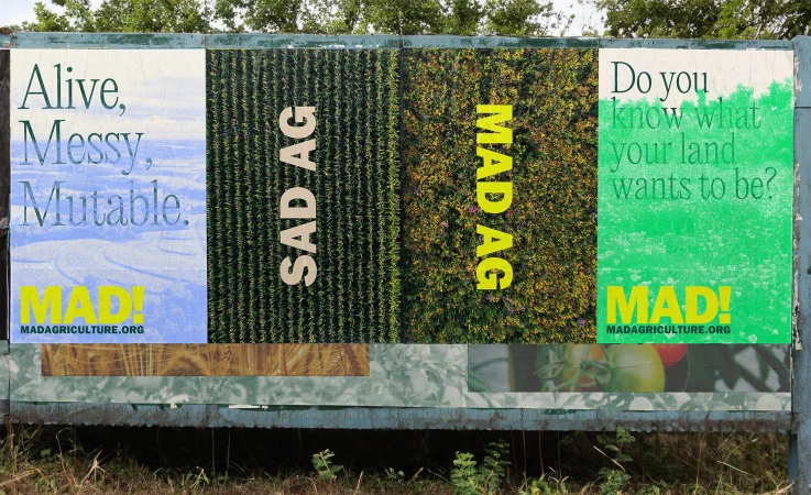 Billboard showcasing agricultural themes with text overlays like 'Alive, Messy, Mutable' and 'Do you know what your land wants to be?'