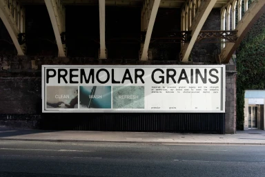 Large horizontal billboard featuring Premolar Grains branding mounted under a stone bridge above a city street.