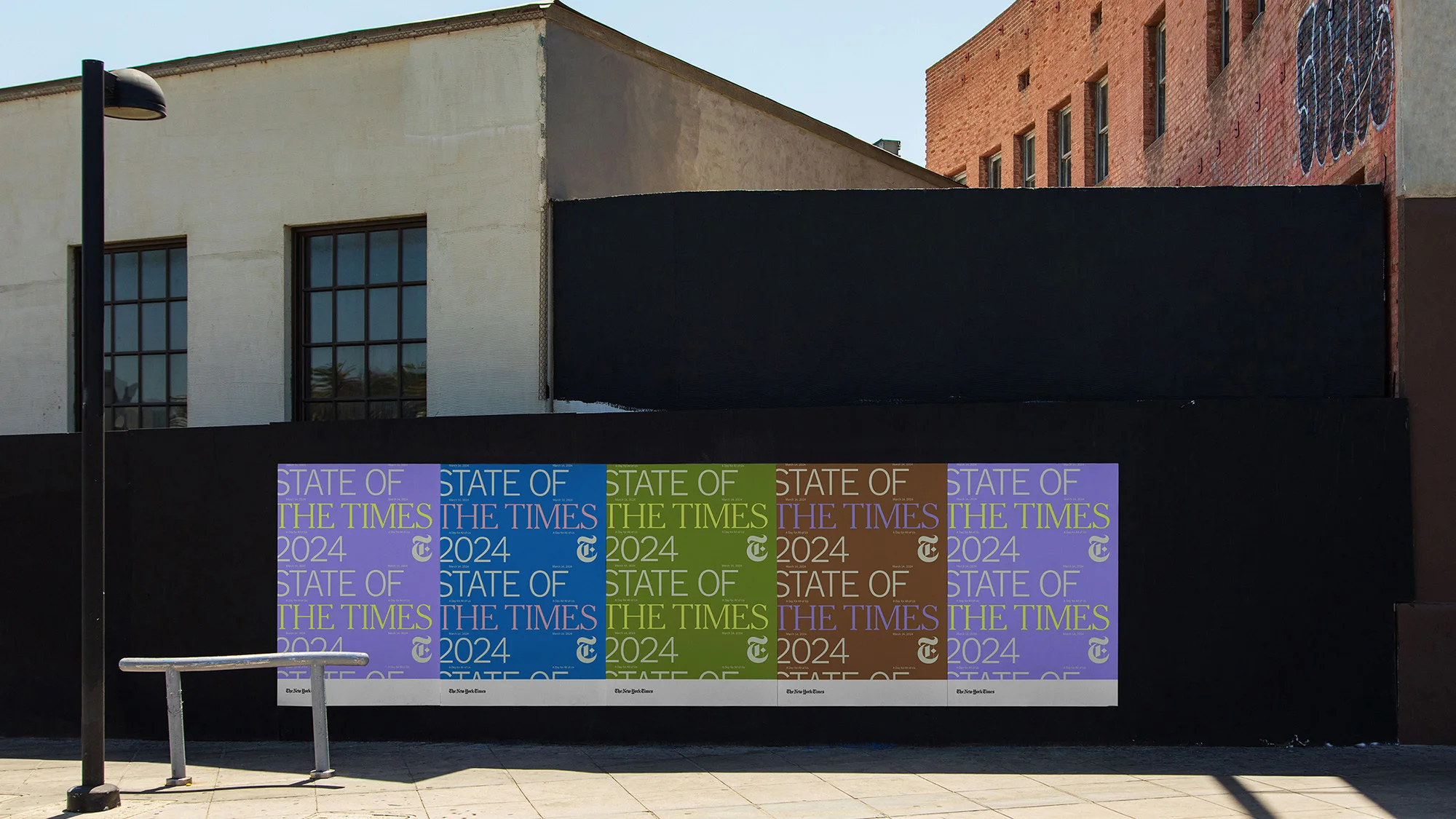 Outdoor advertisement featuring 'State of The Times 2024' on a building exterior with a bench and a street lamp.