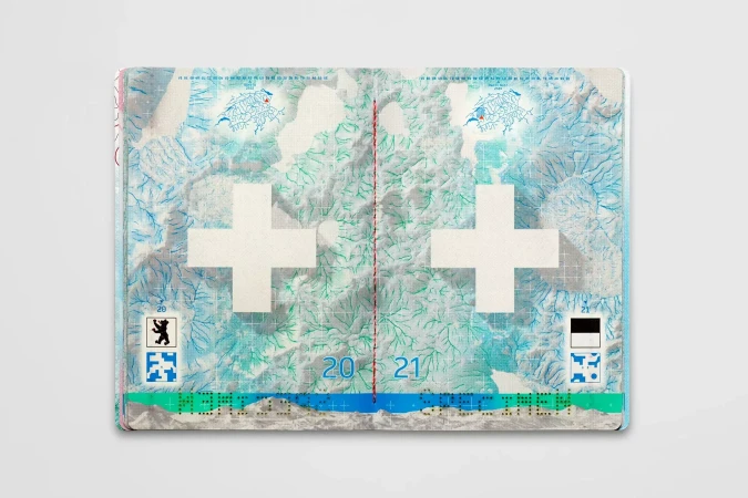 Open Swiss passport displaying an abstract design with a white cross, map, and green and blue colors, set against a gray background.