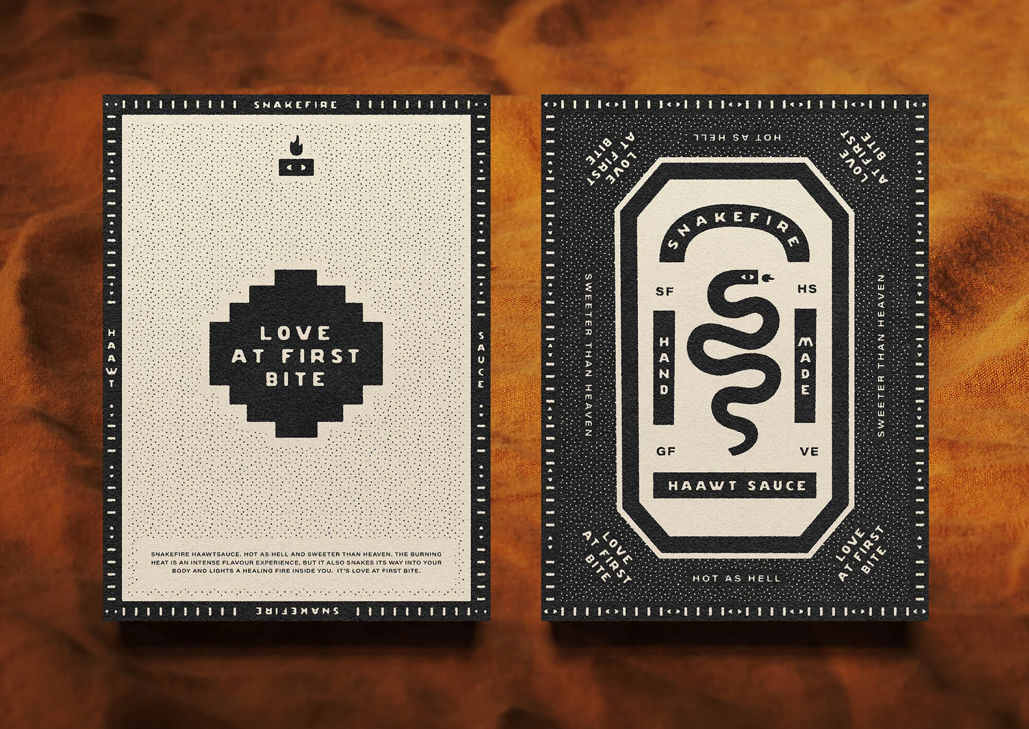 Two hot sauce packages with graphic design featuring a snake and the phrase 'Love at First Bite' against a neutral background.