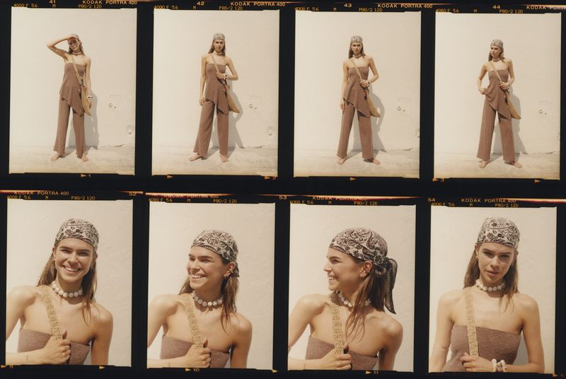 Fashion shot showcases a young woman in a matching set and headscarf, posing against a neutral background, captured through film photography.