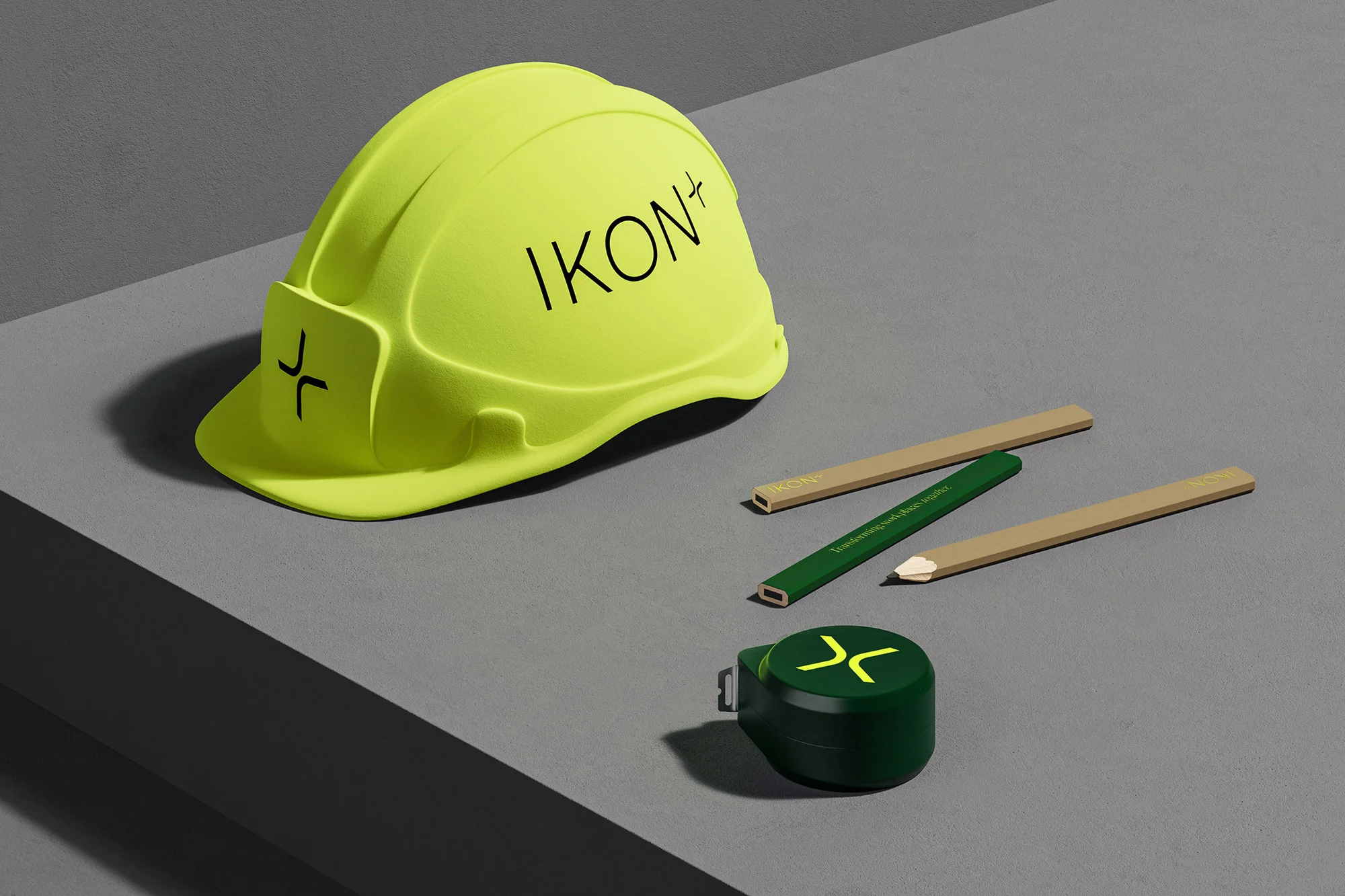 Still life of a construction helmet, pencils, and tape measure on a grey surface, suitable for construction or engineering concepts.