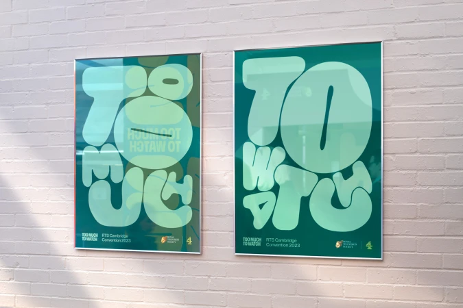 Two framed posters on a white brick wall, featuring bubble-lettered graphics with a color palette of teal, green and white.