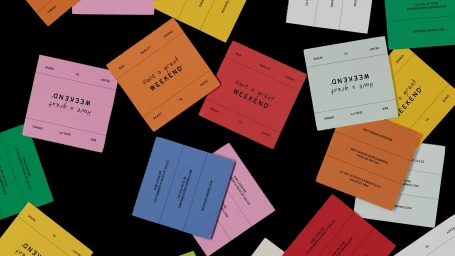Colorful branded packaging squares scattered across a black background for Weekend.