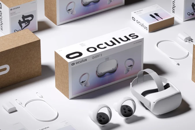 Oculus Quest 2 VR headset with controllers and boxes arranged on a bright surface in a product shot. Technology and gaming concept.