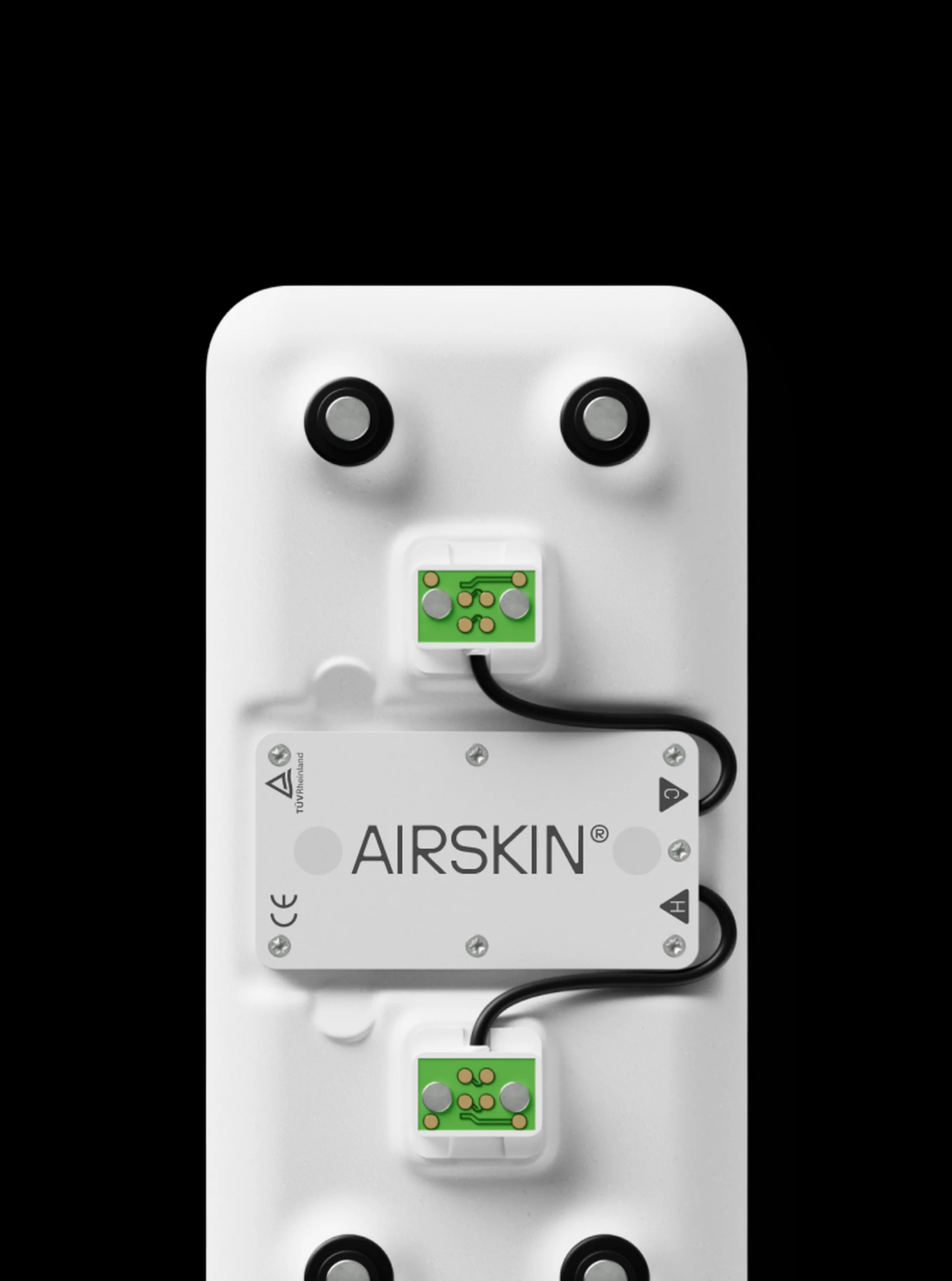 Close-up of an AIrskin® sensor attached to a white surface with black magnets, showcasing technology and healthcare applications.