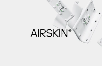 AIRSKIN brand identity display showing white curved modular pneumatic safety sensors floating against a light grey background