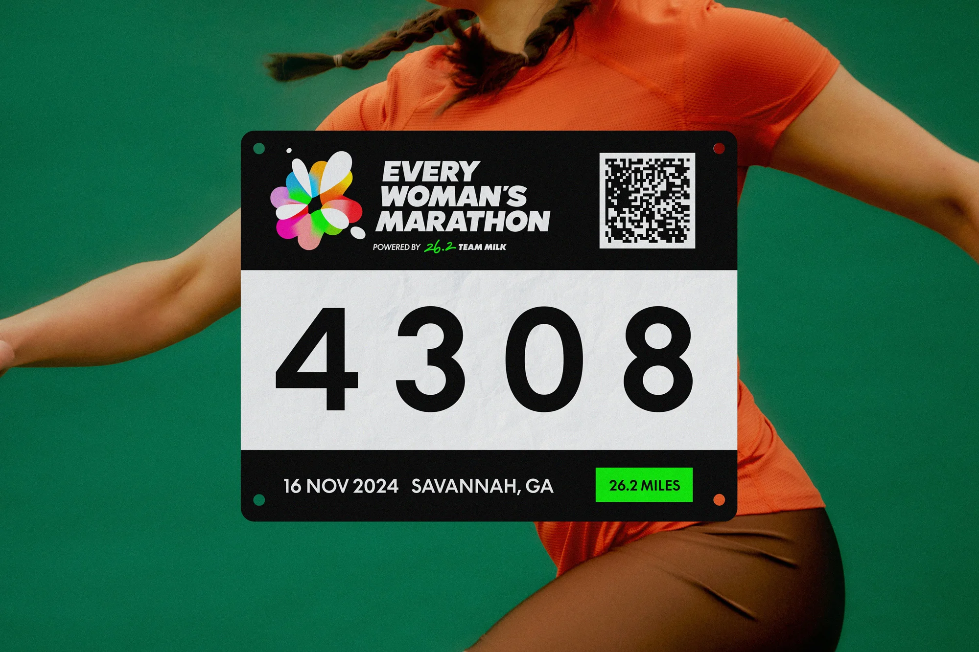 Woman wearing a marathon bib with the text 'Every Woman's Marathon', number 4308, date 16 Nov 2024, and location Savannah, GA.