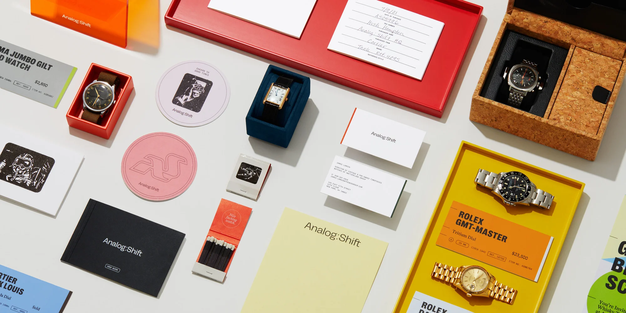Analog Shift product showcase featuring luxury wristwatches, branding materials, and display accessories in a brightly lit studio setting.