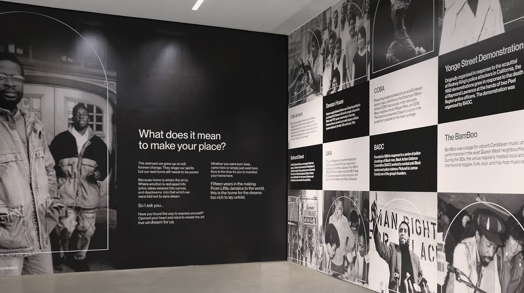 Black and white photo of a wall with pictures of Black people and text about them, including quotes about making your place.